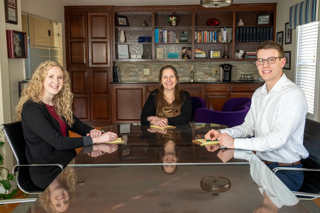 financial planners sitting at a table discussing retirement plans.